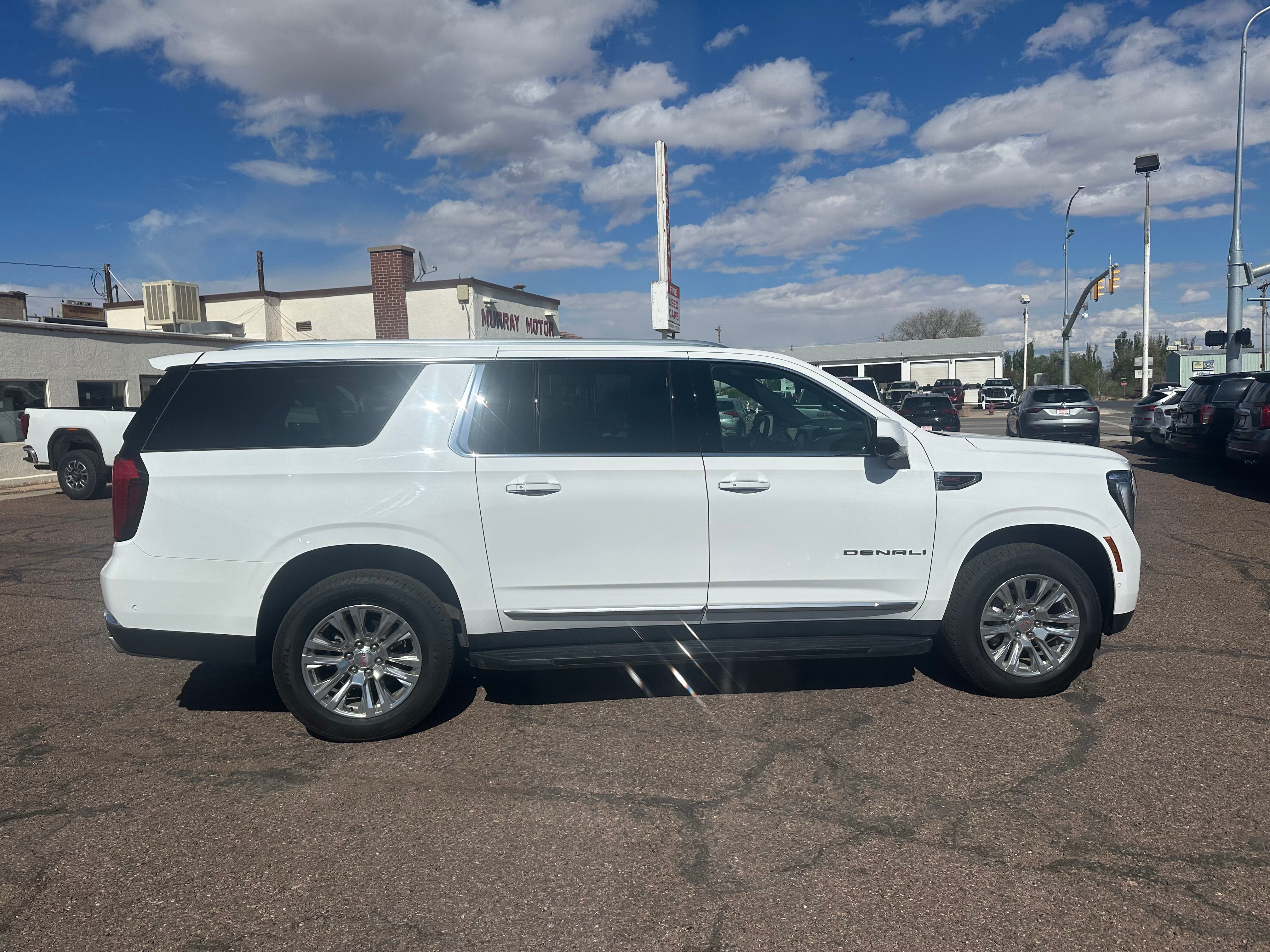 2025 GMC Yukon XL Denali in Summit White — front three-quarter view